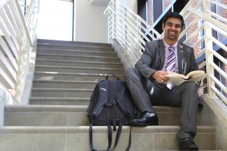 student sitting at stairs at college of education