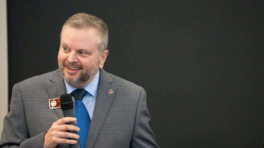 Damon Andrew speaking into a microphone