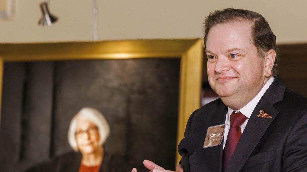 Damon Andrew speaking at a podium