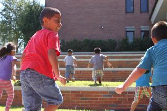 kids running in the yard at college of education