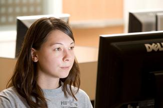 student looking at a computer monitor